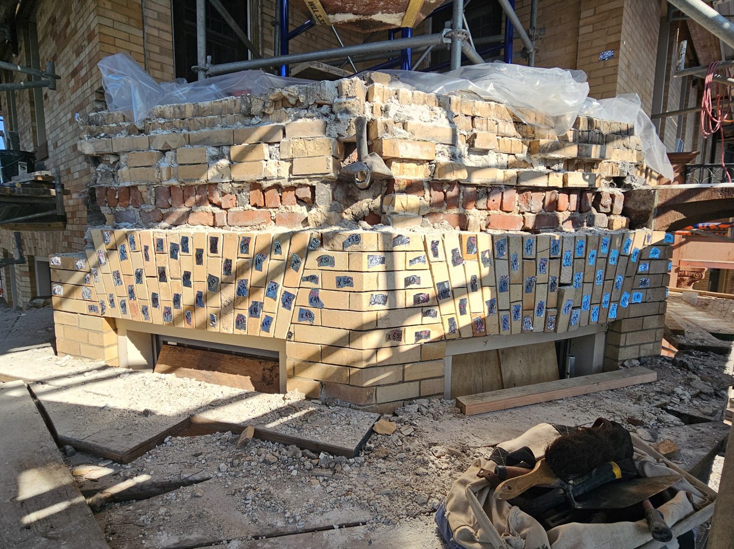 a historic brick masonry parapet during reconstruction