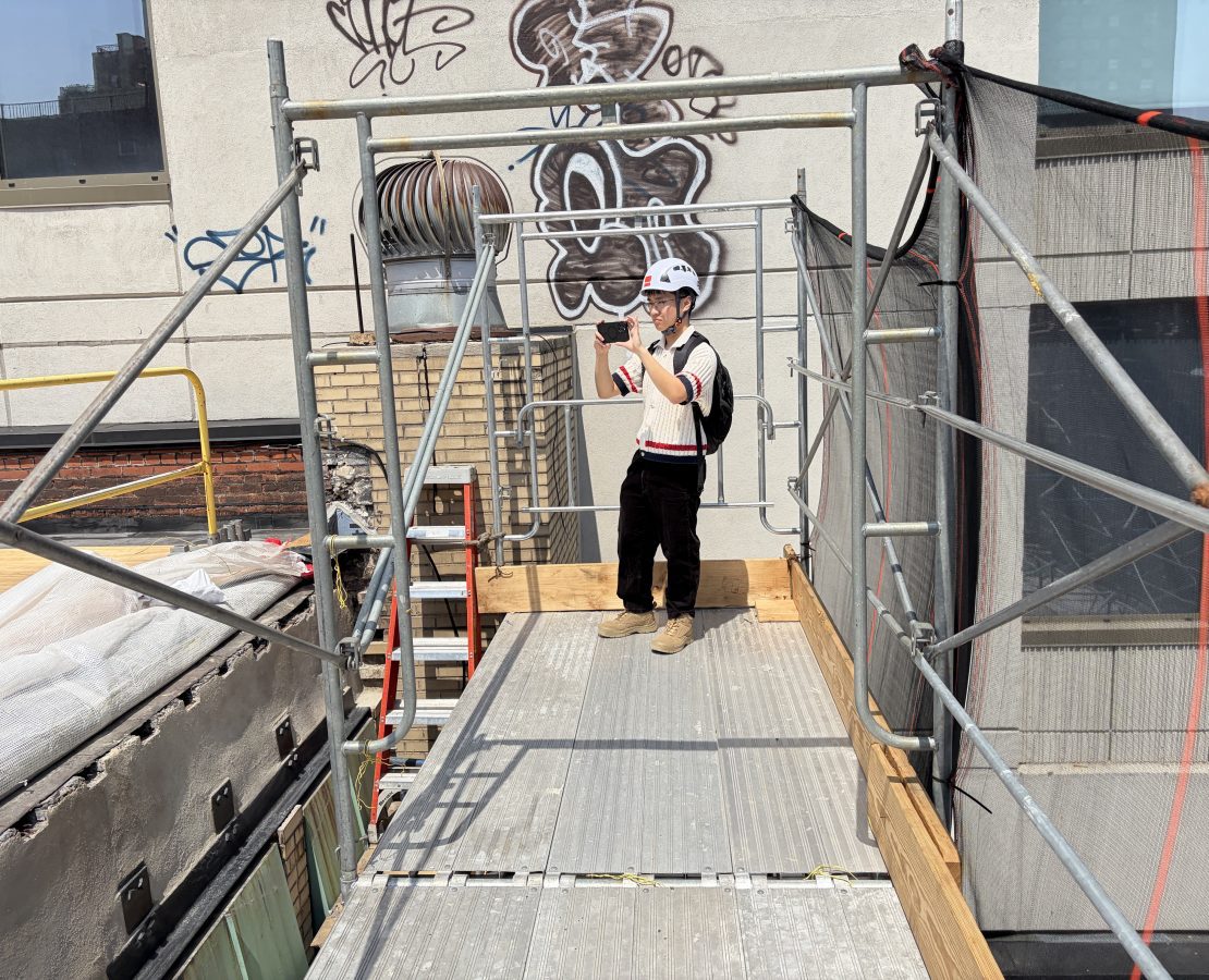 A design professional photographs a roof under construction