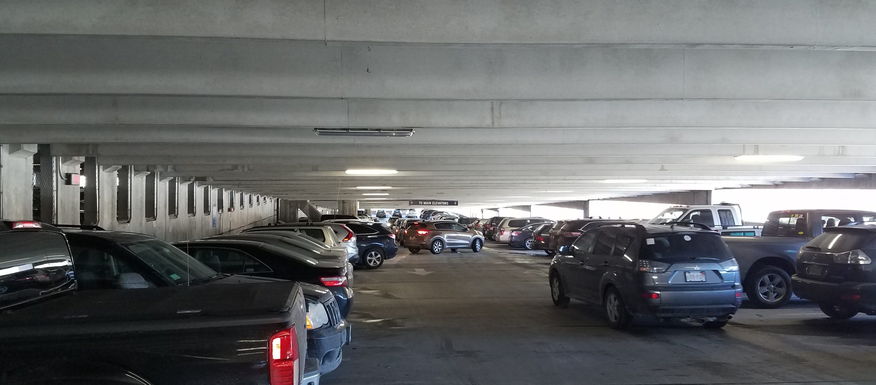 Lahey Hospital and Medical Center parking garage interior, showing parked and moving vehicles
