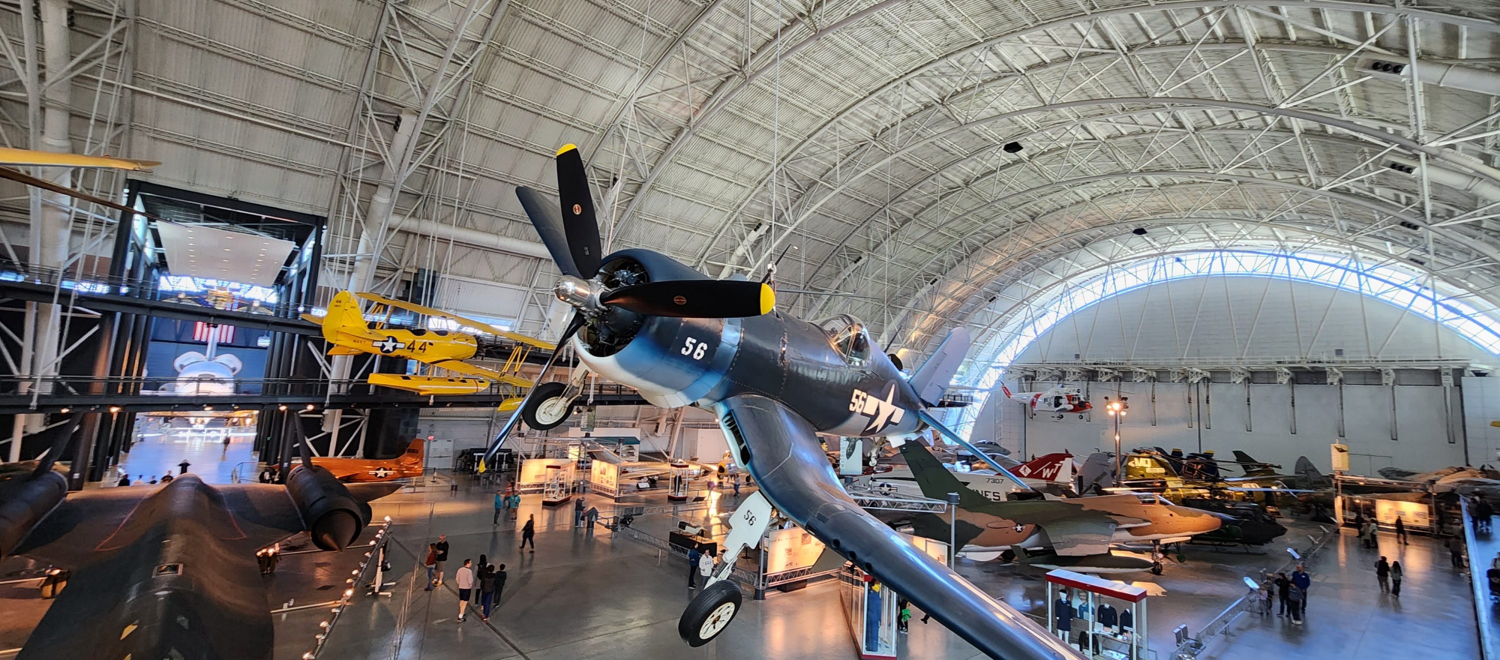 A historical aircraft suspended from the ceiling in the hangar of the Udvar-Hazy Center