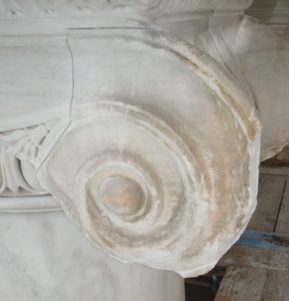 Deteriorated marble column capital prepared for rehabilitation