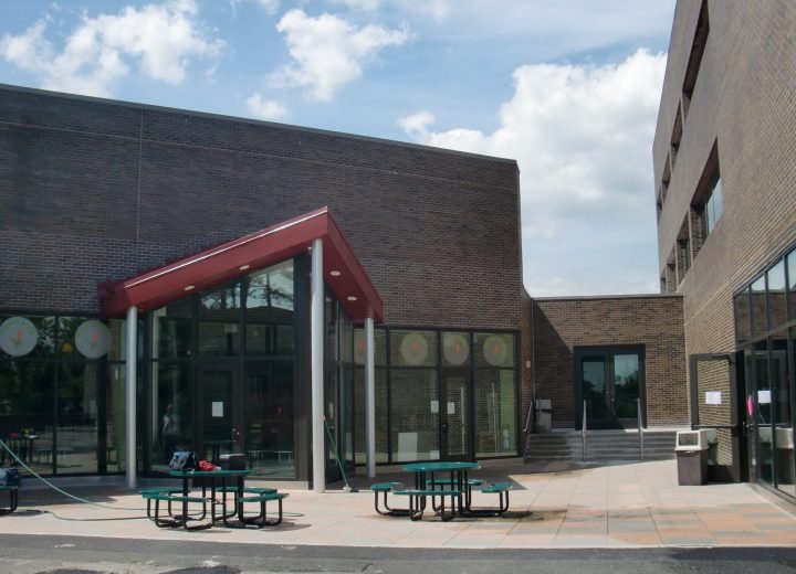 Plaza outside a college student center with picnic tables and campus dining