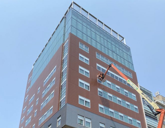 A facade inspection underway at Chapin School in NYC, with a lift in operation