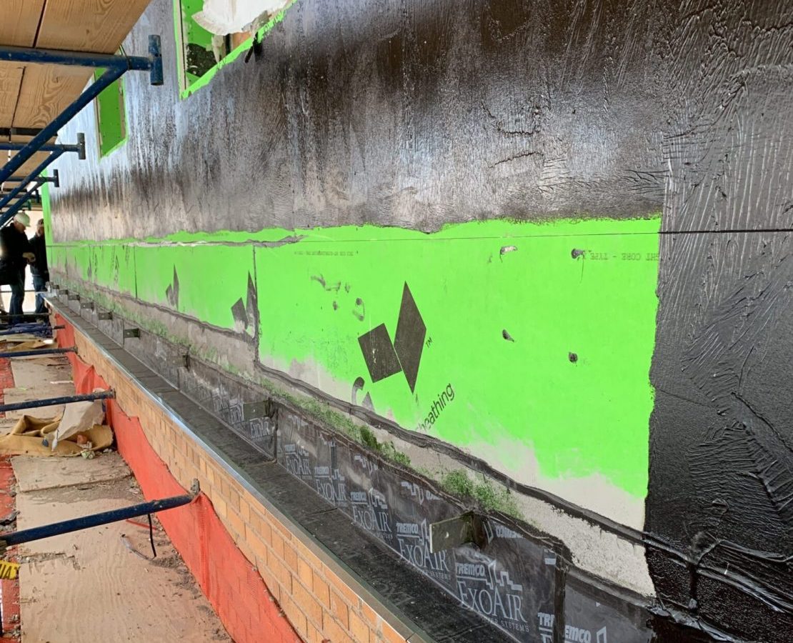 Insulation and continuous air barrier in an exterior wall under construction.