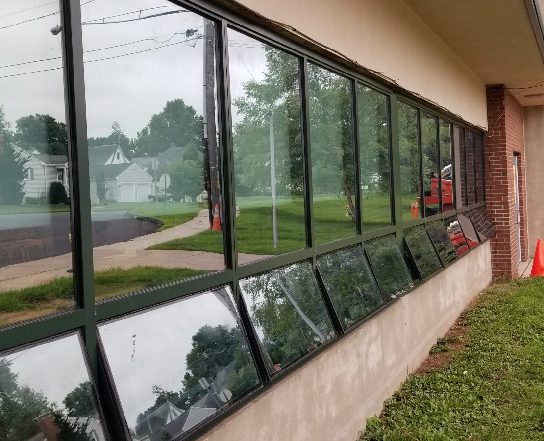 New replacement windows, with lower awning-style portion open, at a one-story grade school