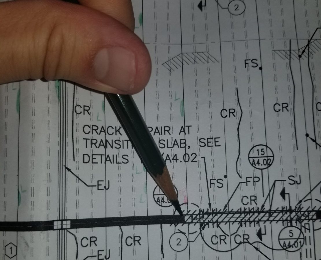 Close-up detail of pencil pointing to parking garage plan