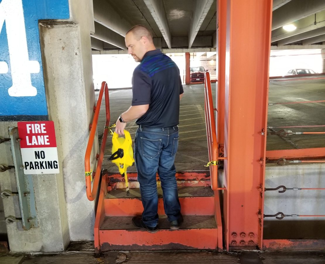 An engineer inspecting a parking structure