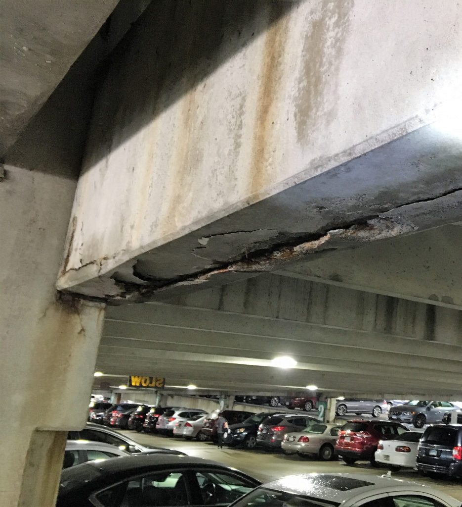 Corrosion and spalling of precast concrete parking garage beam