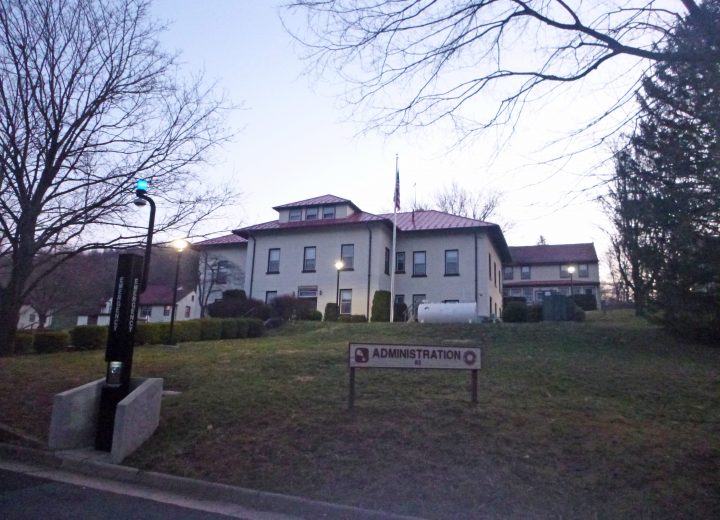 An administration building on a hillside at dusk