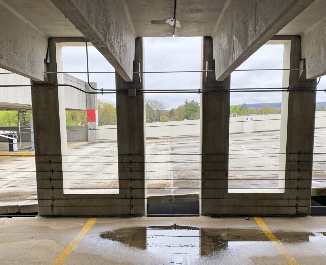 Double-tee parking structure with pooled water below deck joints