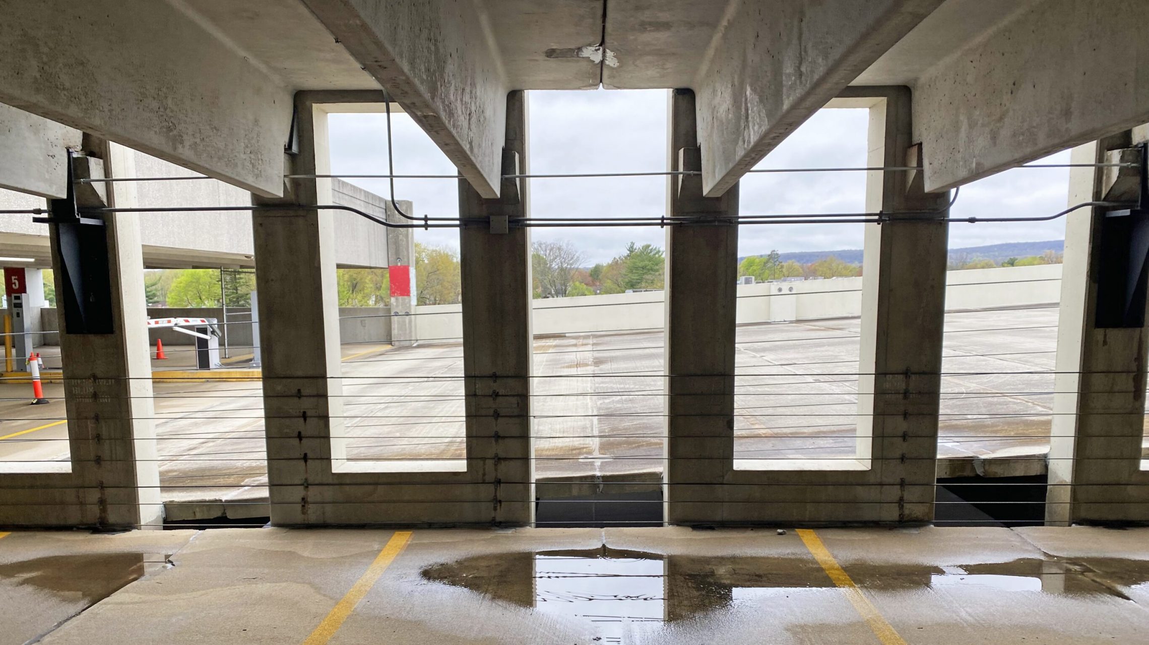 Double-tee parking structure with pooled water below deck joints