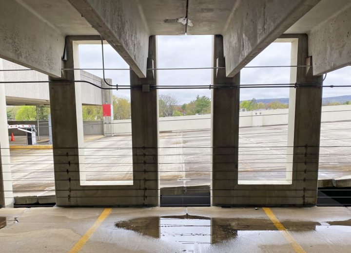 Double-tee parking structure with pooled water below deck joints