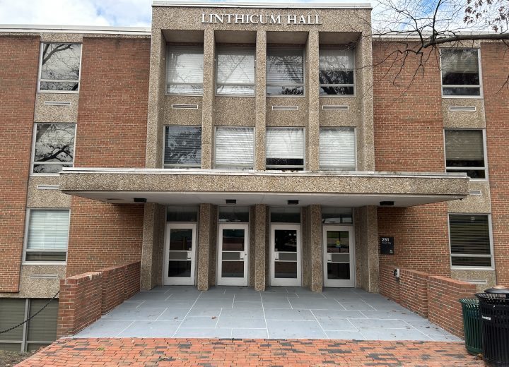 Front entrance to a 1950s university building clad in brick masonry