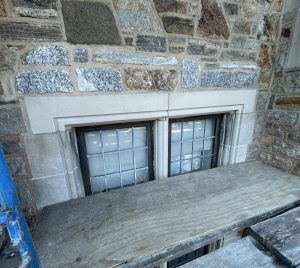 Cast stone window header in place of limestone at historic building