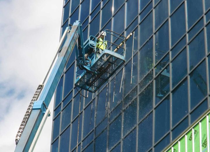 Construction worker performing water test on a building
