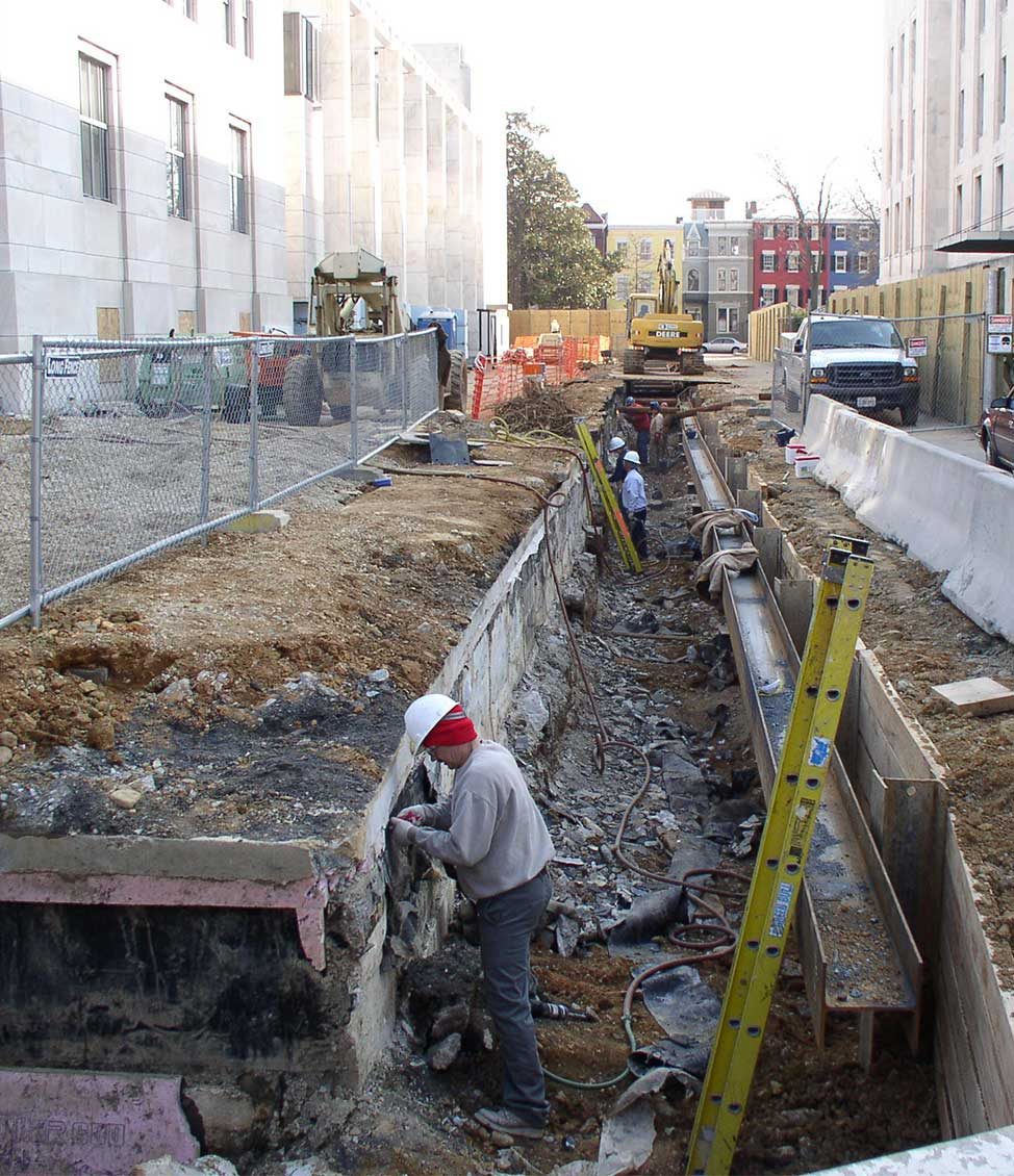 Construction workers performing waterproofing treatments