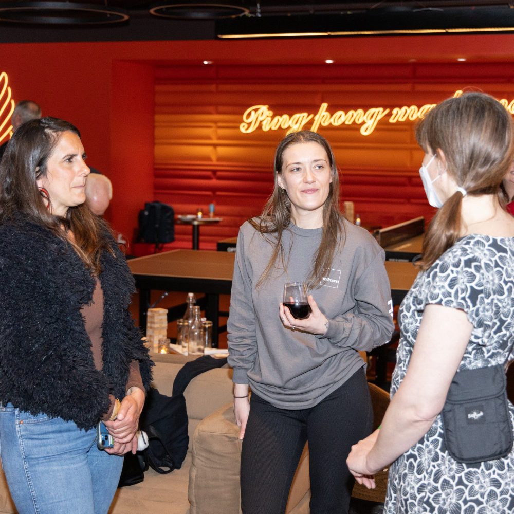 Three female Hoffmann Architects and Engineers employees at a team-building event.