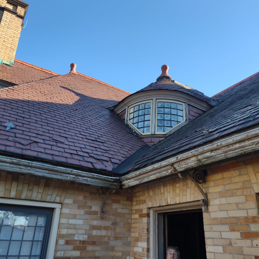 Displaced shingles on a slate roof