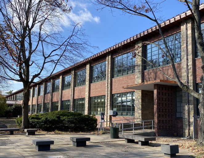 View of one of the entrances to the deceptively large, serpentine SUNY Farmingdale Lupton Hall, with the newly installed copper roof above