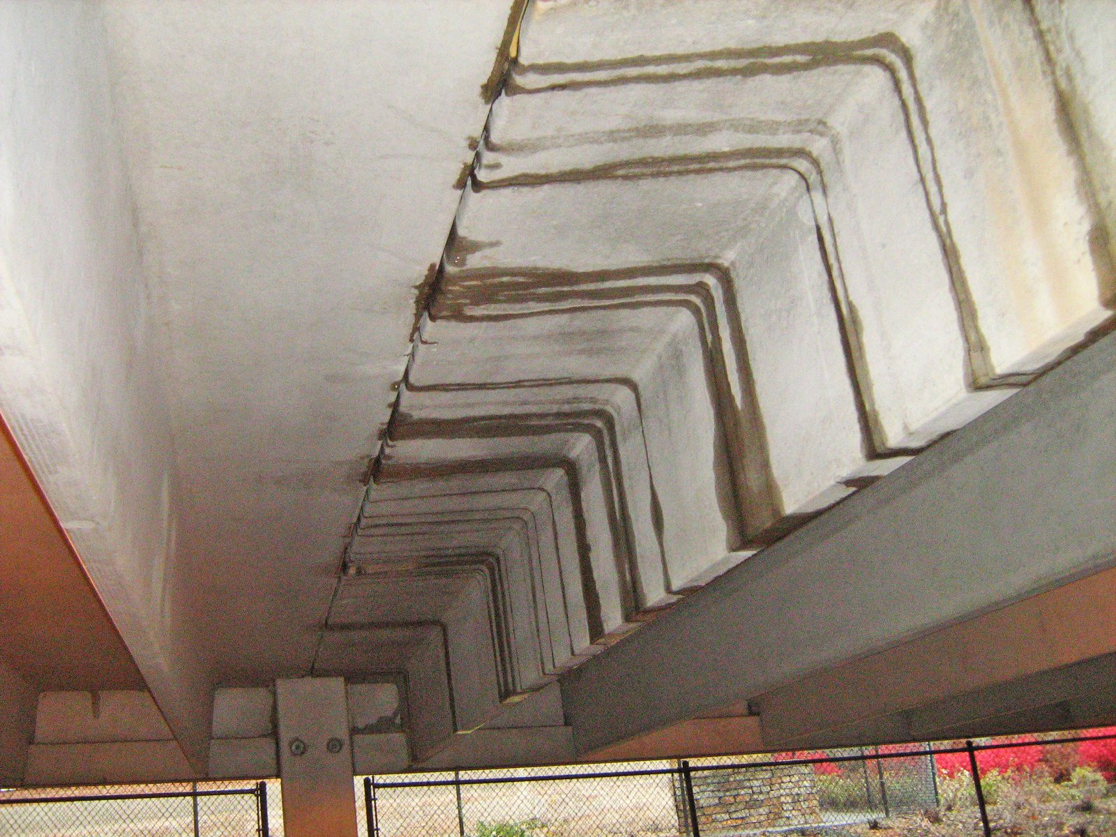 Continuous leaks at a parking garage deck joint, which indicate failed sealant and, possibly, an unzipped joint.