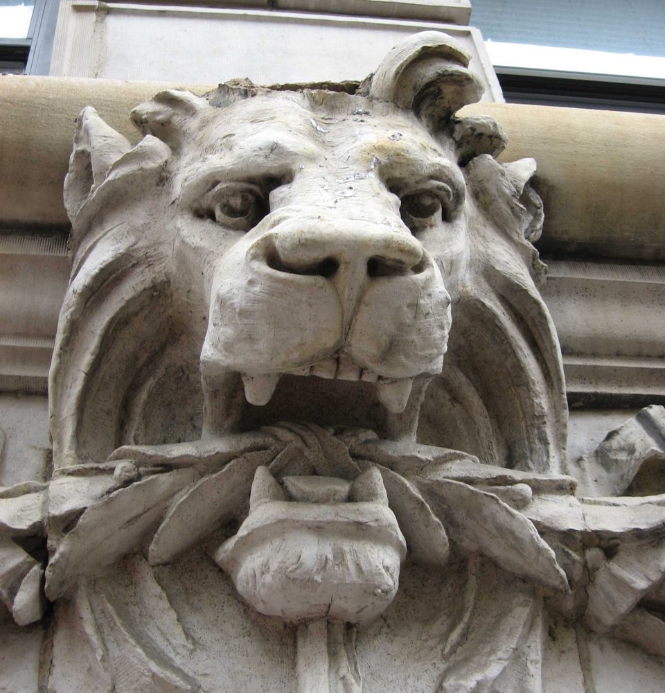Damage to terra cotta lion head facade element